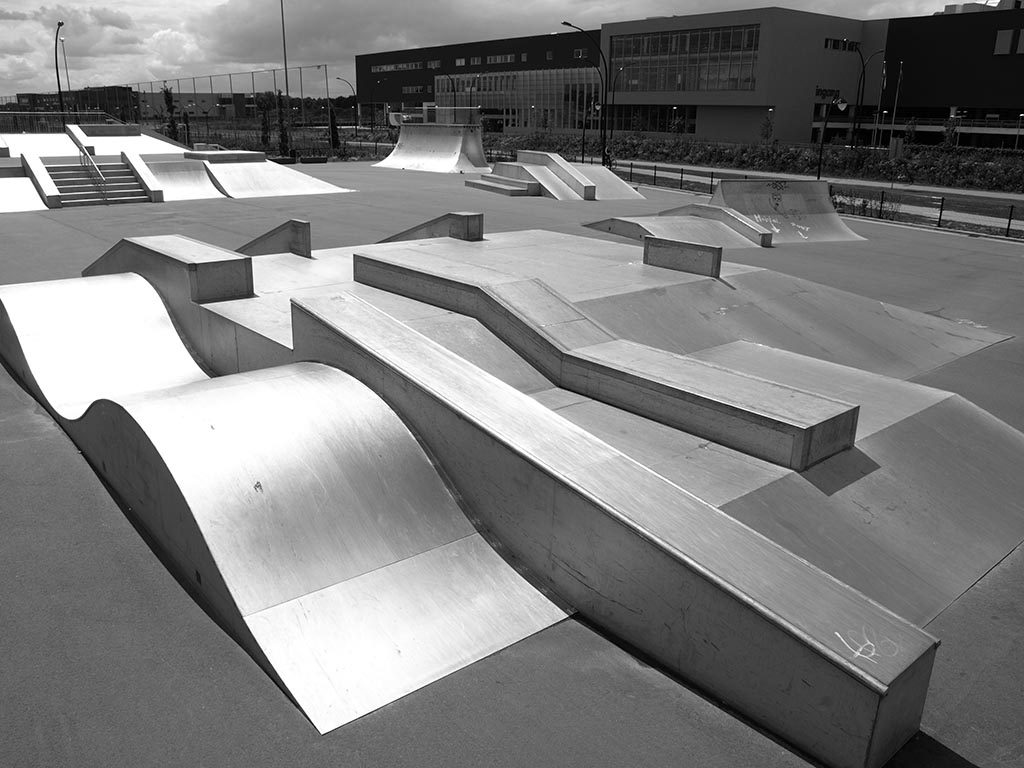 Modular steel skatepark with wave ramps, manual pads, ledges and quarter pipes