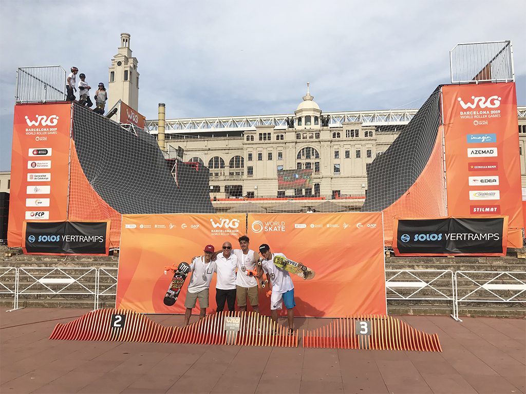 Riders on the podium in front of the vert ramp at the World Roller Games 2019 in Barcelona